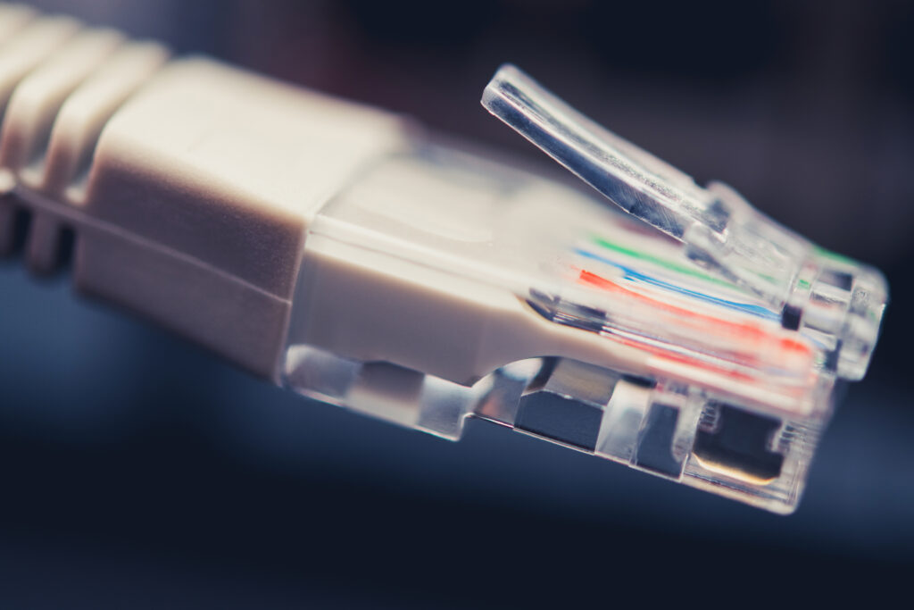 Networking Theme. RJ45 Ethernet Cable Close Up. Connecting Devices Into Internet Network.